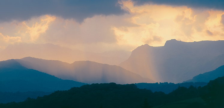 Shafts of sunlight over the Langdale Pikes copyright Val Corbett