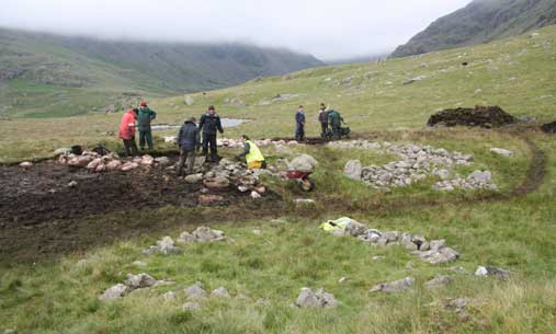 Seathwaite Ring cairn with large one being de-turfed