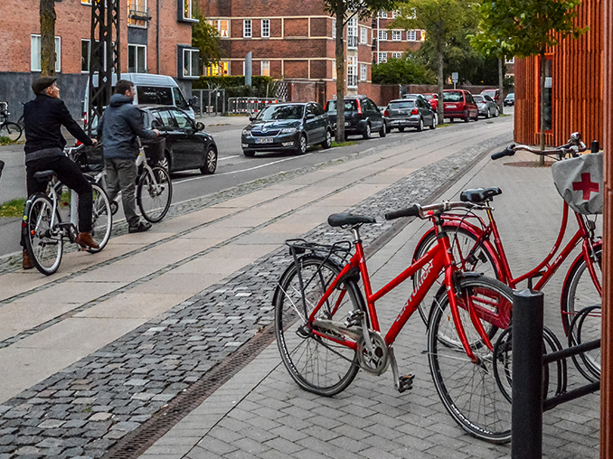 Bikes parked on a cobbled street in Copenhagen.