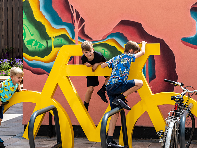 Children climbing on bicycle parking.