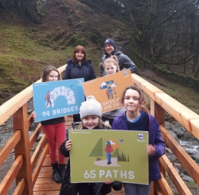 Lake District National Park Chief Executive Richard Leafe and Jacquie Middleton from the Rural Payments Agency alongside some local youngsters who helped celebrate the completion of the Routes to Resilience Programme at Greenhead Gill Bridge in Grasmere.