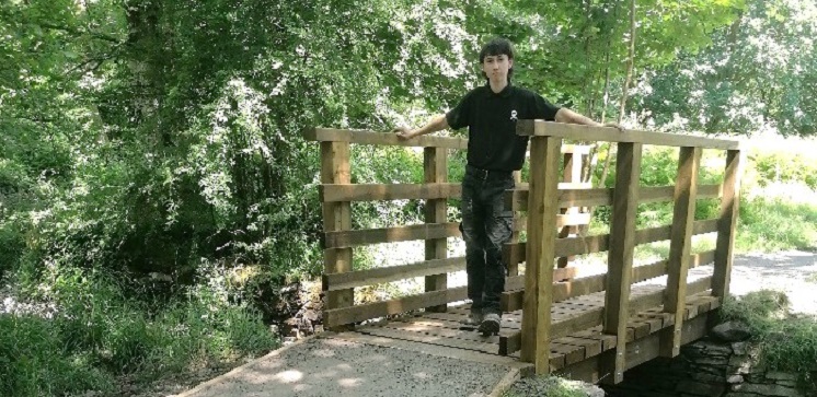 Jed Porter standing on a bridge he mended.