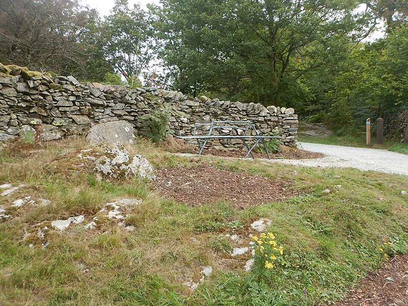 The path passes through a gap in the wall at post 12.