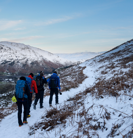 Walkers exploring Helvellyn in the snow.