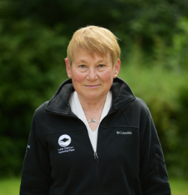 portrait of Tiffany Hunt with trees behind her 