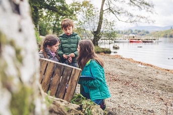 Children playing by a lakeshore