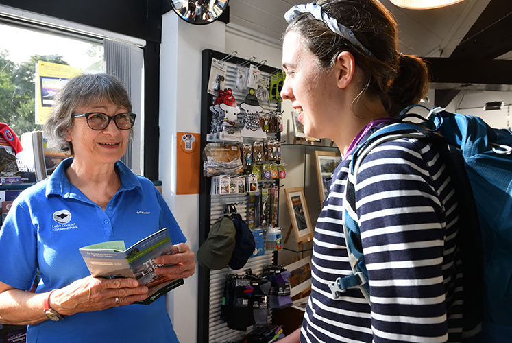 Friendly information centre staff chatting to a visitor