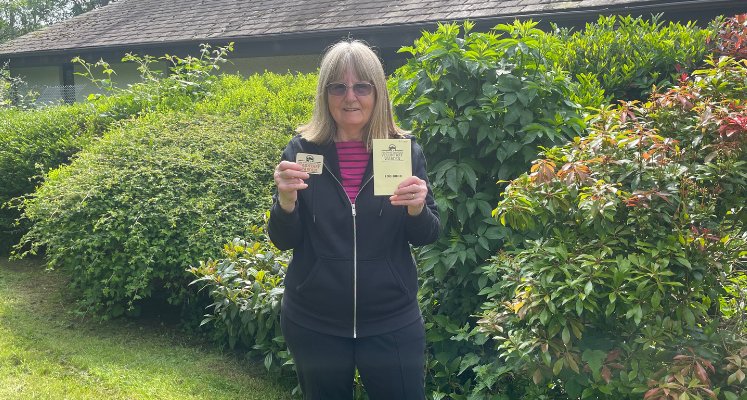 Bev holding her first Warden's badge and logbook