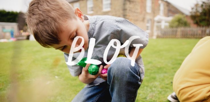 young boy doing an Easter egg hunt in his garden