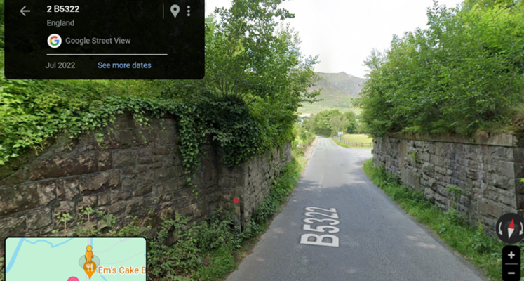 Road with walls and greenery either side