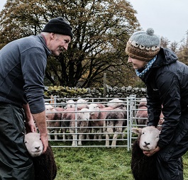 Andrea Meanwell and a farmer with sheep.