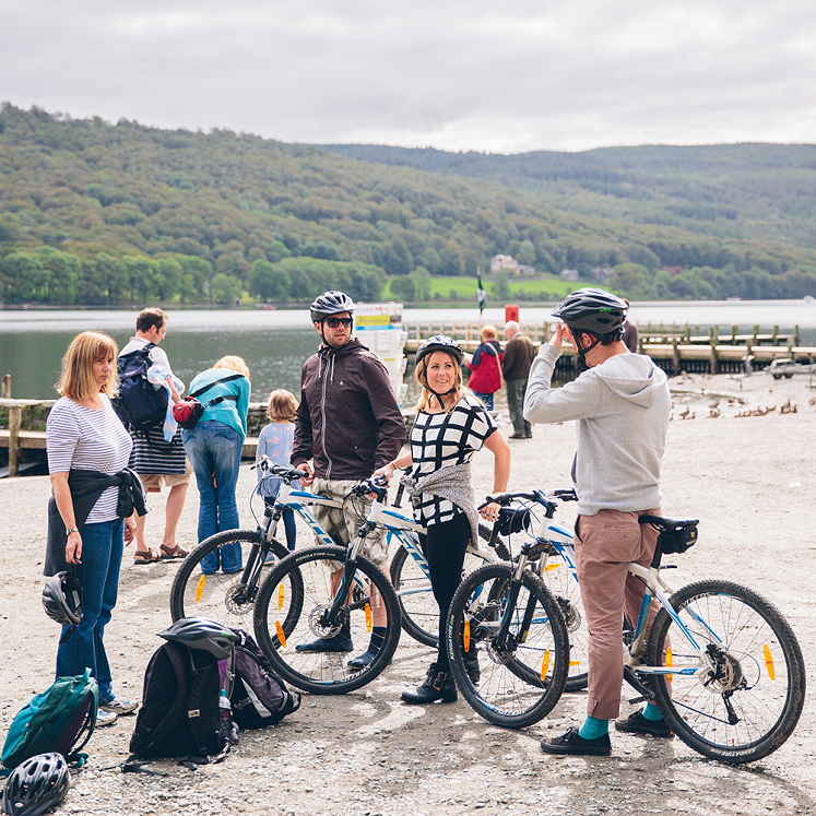 a group of people with bikes and helmets