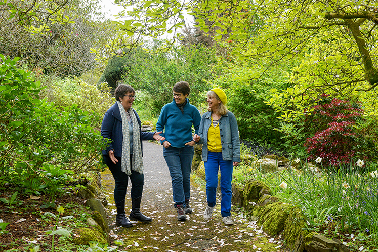 Brockhole volunteers - three people stood in the grounds