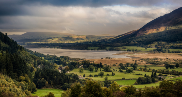 clouds reflecting into a still Bassenthwaite lake with mountains in the distance