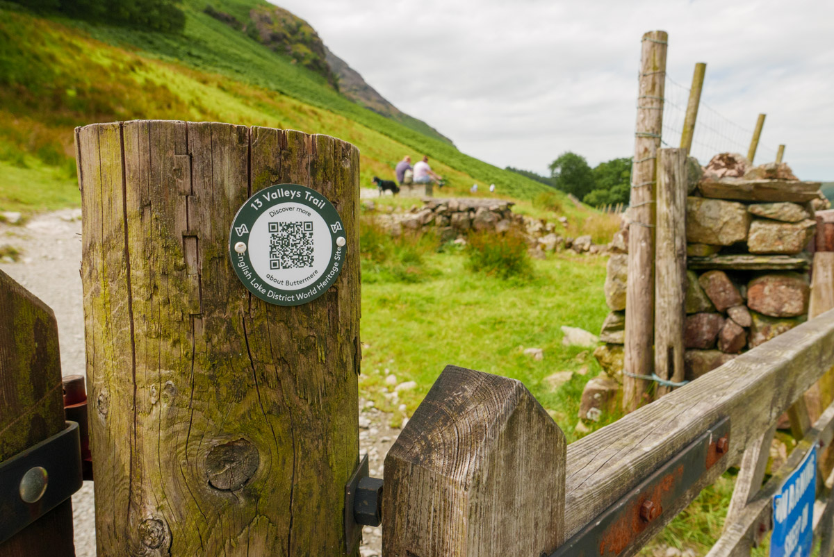 green 13 valleys roundel with QR code on post in the Lake District