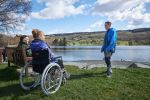 Wheelchair user by a lake shore - Adrian Naik