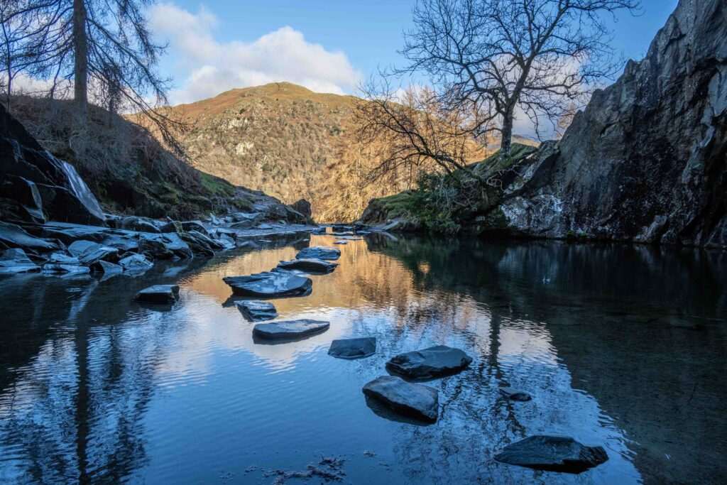 Looking out of Rydal cave which is full of water with stepping stones visible