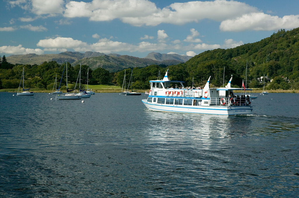 Picture of Windermere Lakes Cruises ferry at North of Windermere Lake with Langdales in the background, tourism in the Lake District