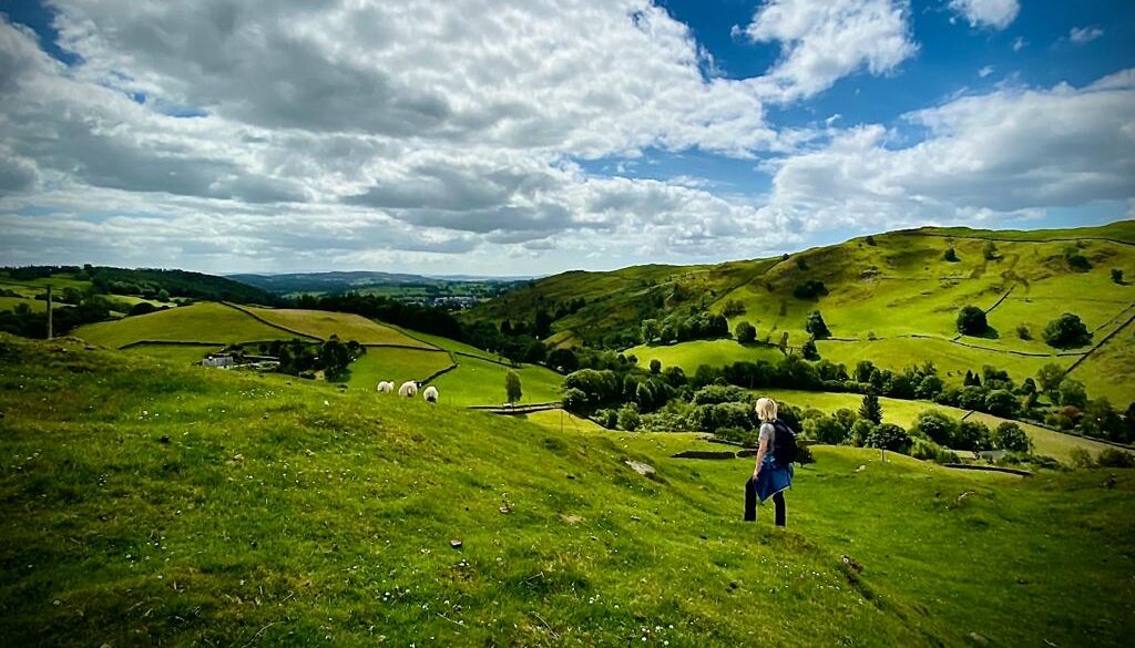Rolling green hills and a blue sky with white clouds in the Kentmere Valley, Lake District