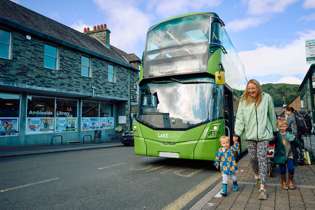picture of a family next to a bus
