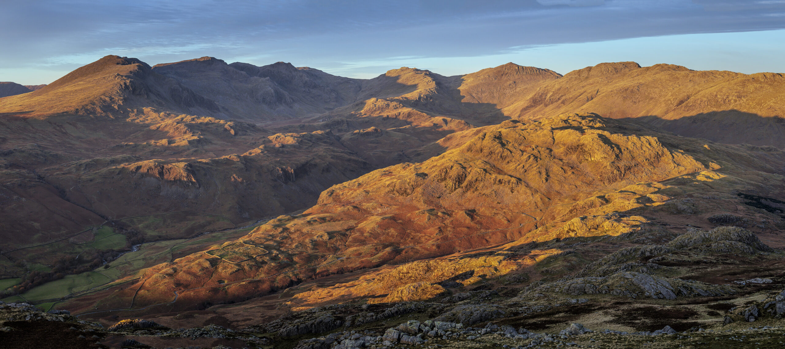 fell top landscape view of upper eskdale at sunset