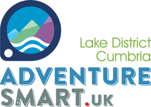 Text reads 'Adventure Smart.uk', 'Lake District Cumbria'. Round graphic logo of purple. green and blue mountains, white and blue wave, blue 'sky' and white dot in bottom left corner of logo