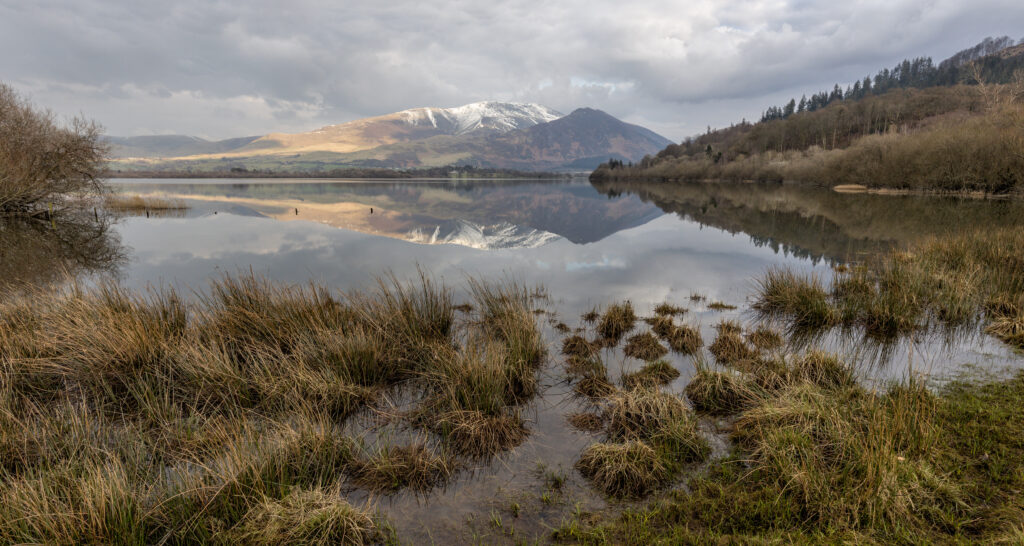 Bassenthwaite Lake from the shore looking towards snowy topped mountains