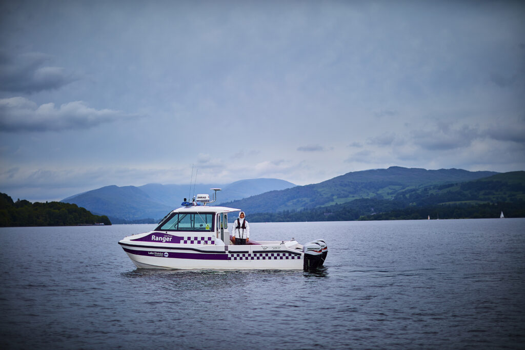 Lake Ranger boat on lake with mountain in distance