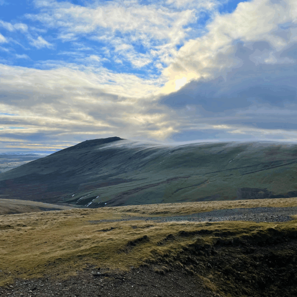 Caldbeck Common in the Lake District, a fell on an overcast day with cloud rolling along the top of the fell