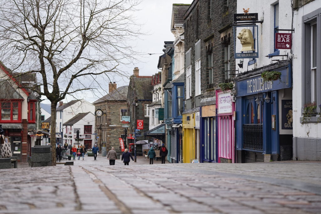 cobbled path of Keswick town centre with colourful shop fronts