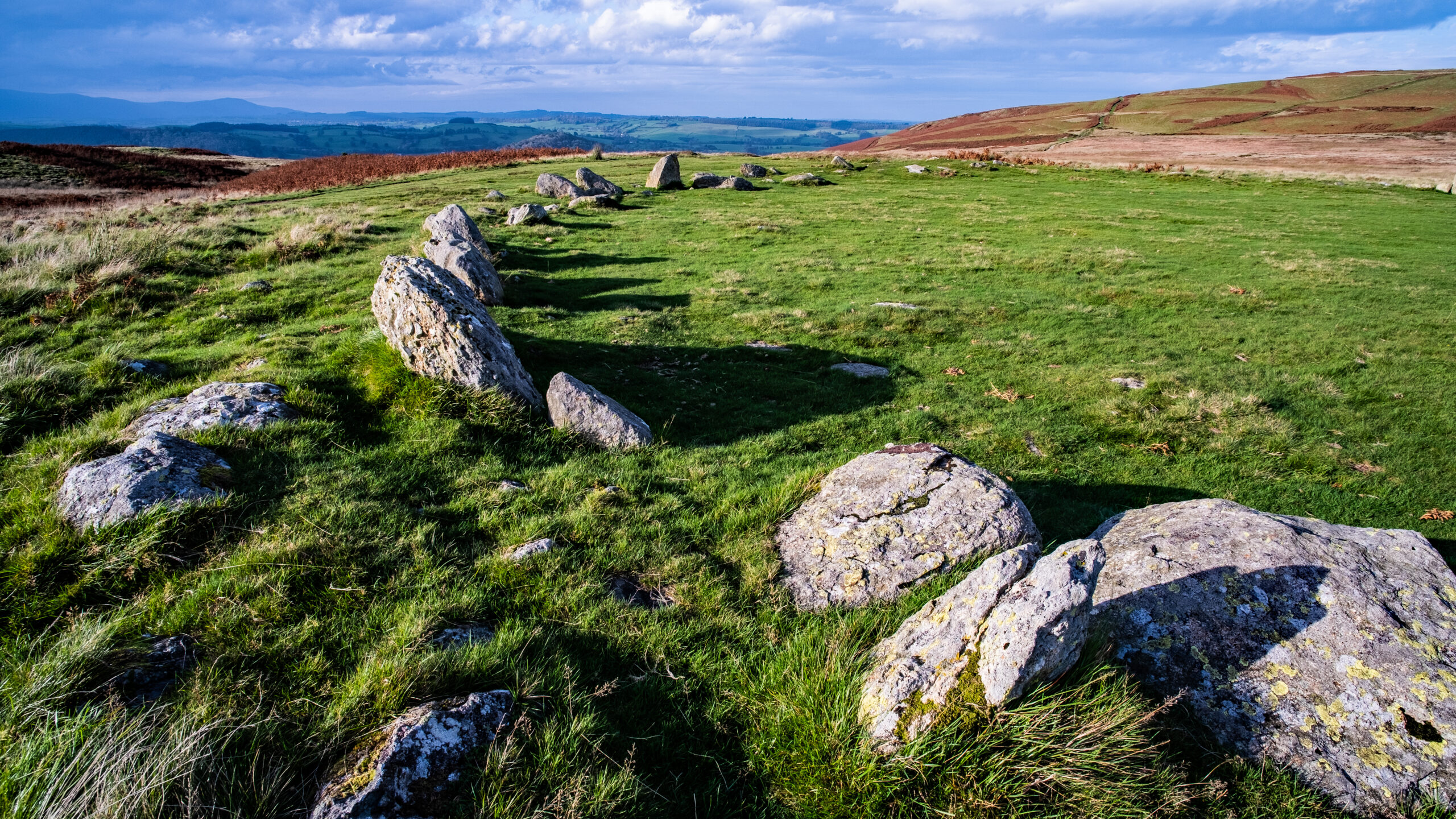 Arial view of the Cockpit stone circle in a green field of grass and fell landscape background on a sunny day