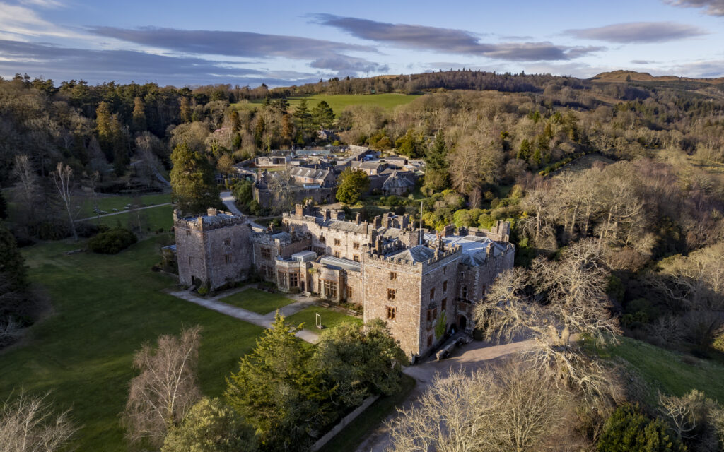 aerial view of muncaster castle and surrounding grounds