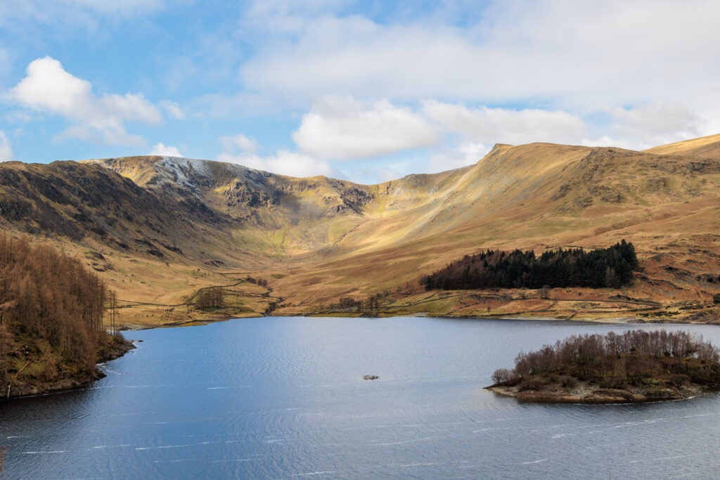 haweswater with surrounding beige fells on a sunny day