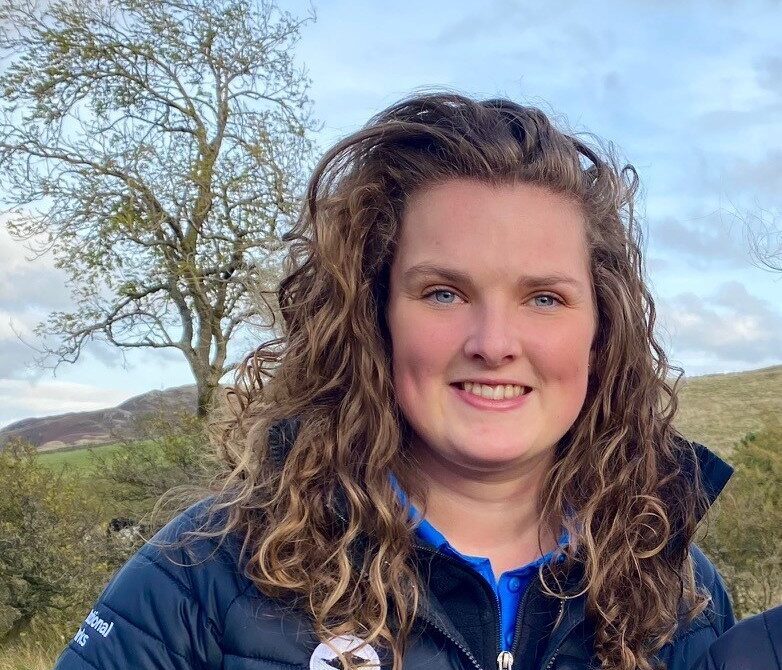 Eliza Hodgson, Farming Officer, who wears a dark LDNPA branded coat and has curly brown shoulder length hair