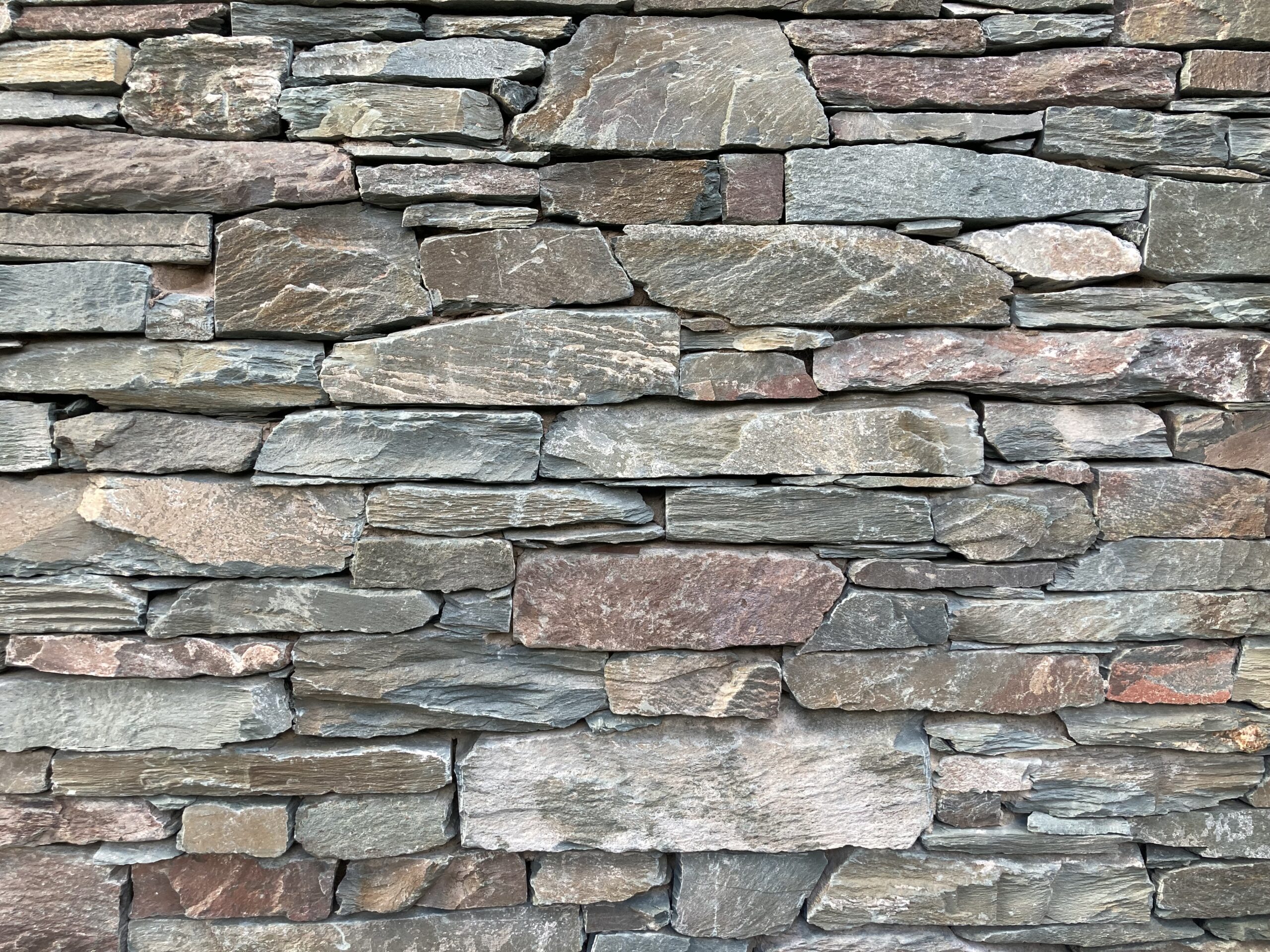 close up of green grey brown slatestone wall