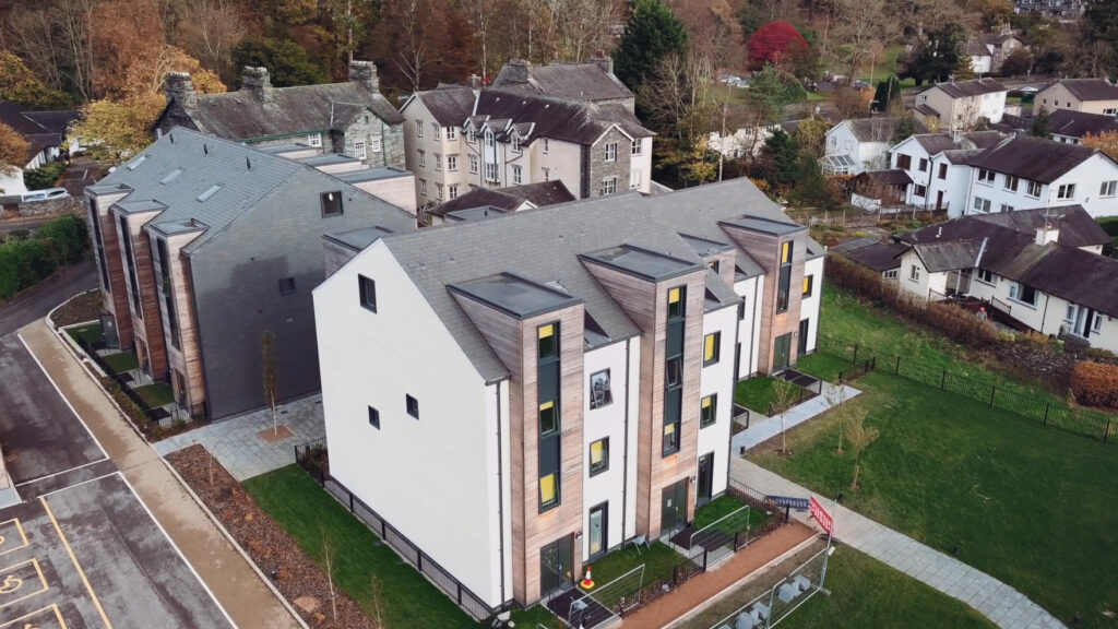 aerial view of new affordable and sustainable flats in a village