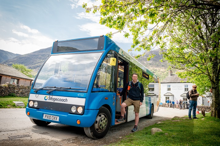 Man in hiking gear boarding a Stagecoach bus.