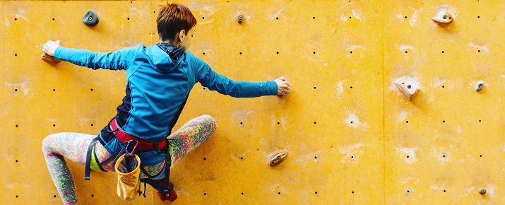 A lady climbing the wall