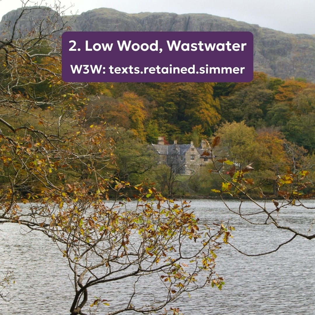 Looking through autumnal trees to large house on edge of Wastwater
