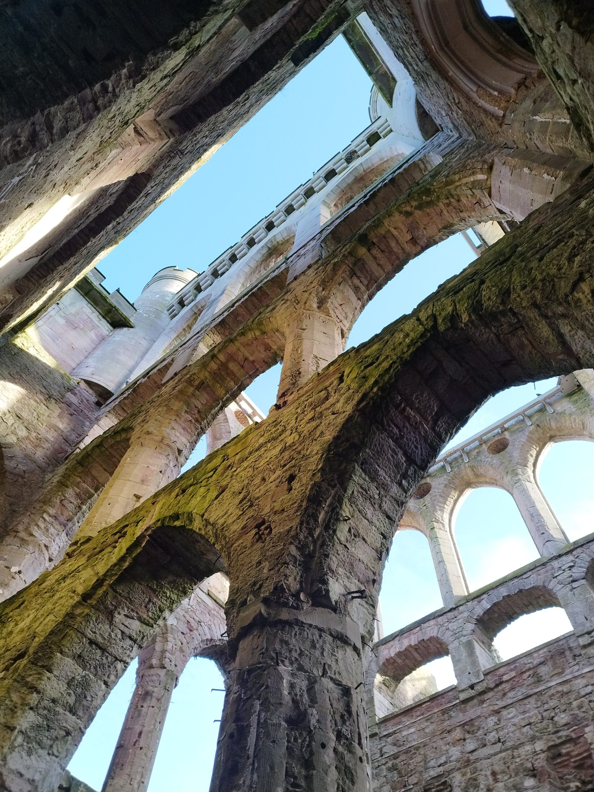 looking up through Lowther Castle remains at blue sky