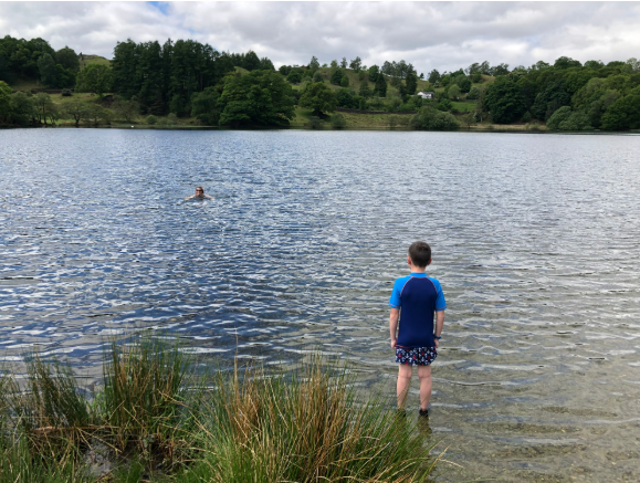 Children taking a dip in Loughrigg tarn
