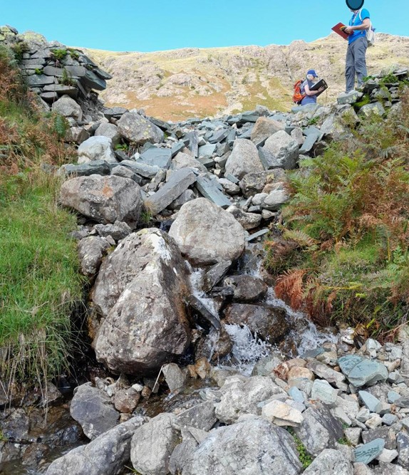 section of washed-out revetment on path