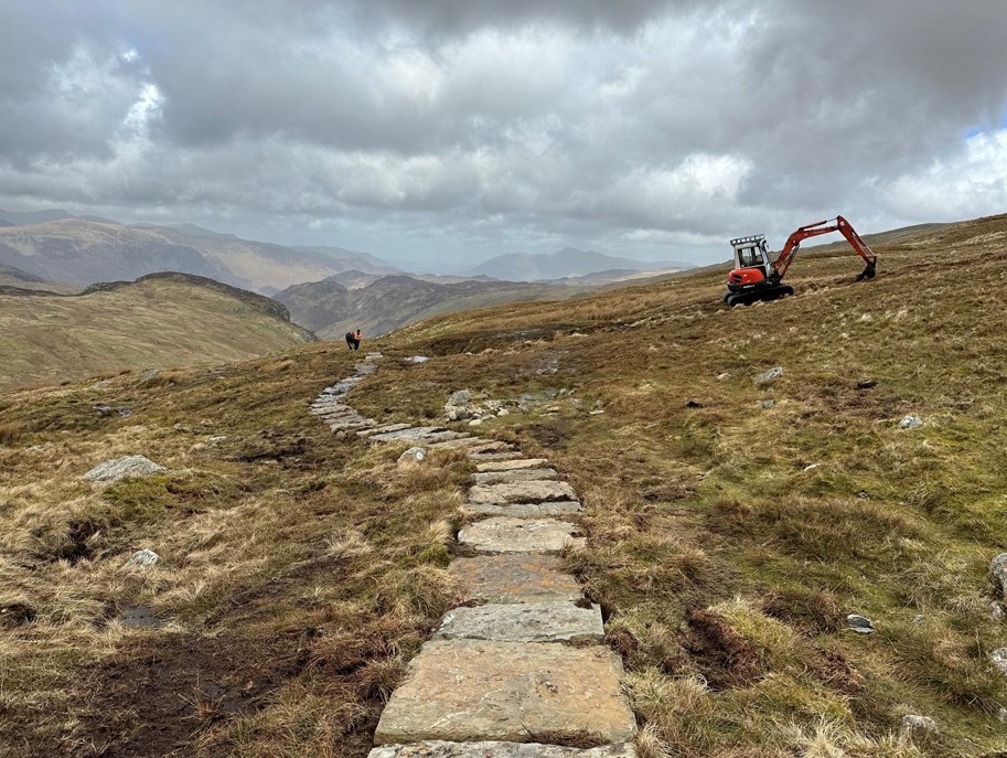 digger beside flagstones on new path