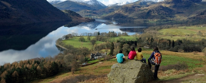 Family looking out and admiring the sunning landscape over Ullswater 
