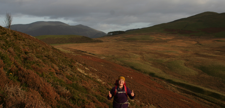 Amy with thumbs up in the Lake District landscape