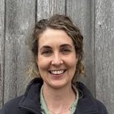 headshot of woman smiling to camera in lake district national park authority uniform