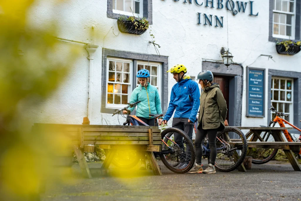 cyclists outside a pub stood next to their bikes