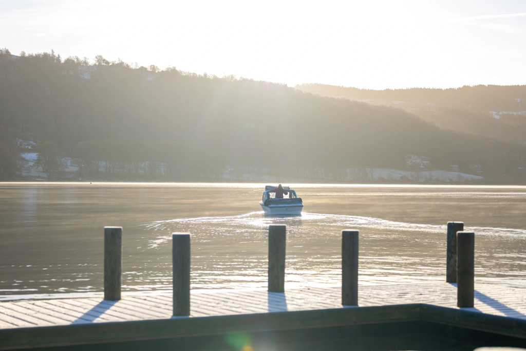 small white motorised boat on a sunny winters day on Coniston Water